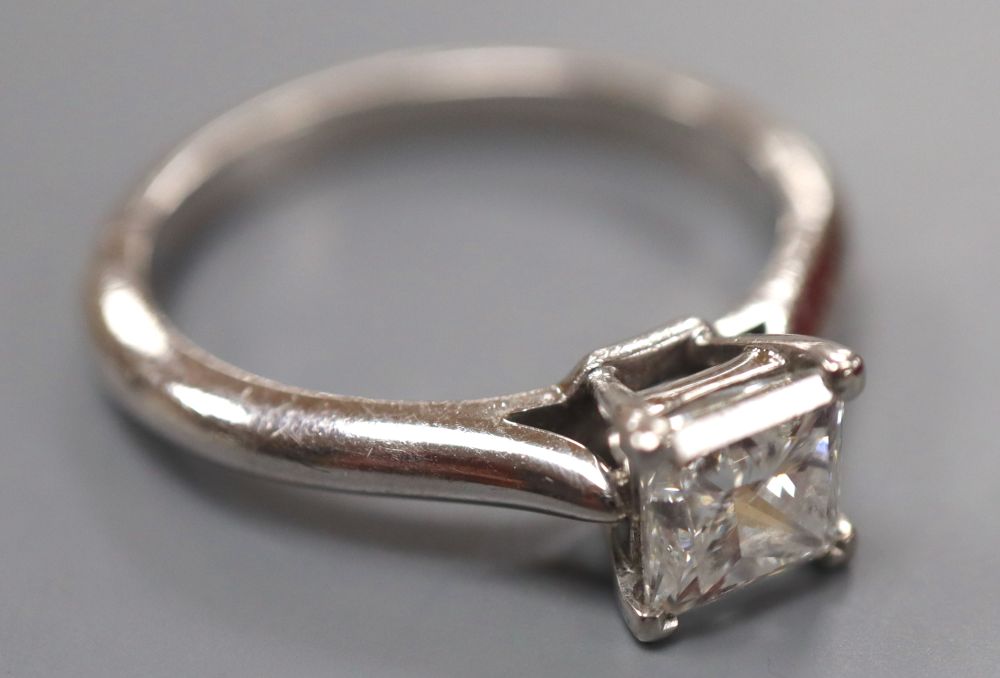 A modern Cartier platinum and Princess cut solitaire diamond ring,